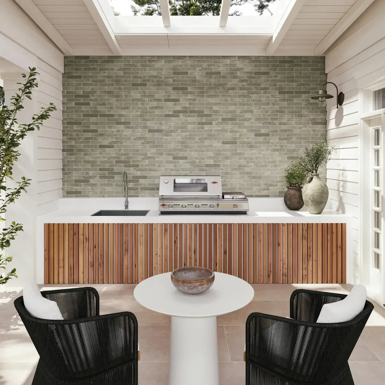 Modern outdoor kitchen with wood accents, sleek appliances, and green tiled wall, ideal for entertaining.