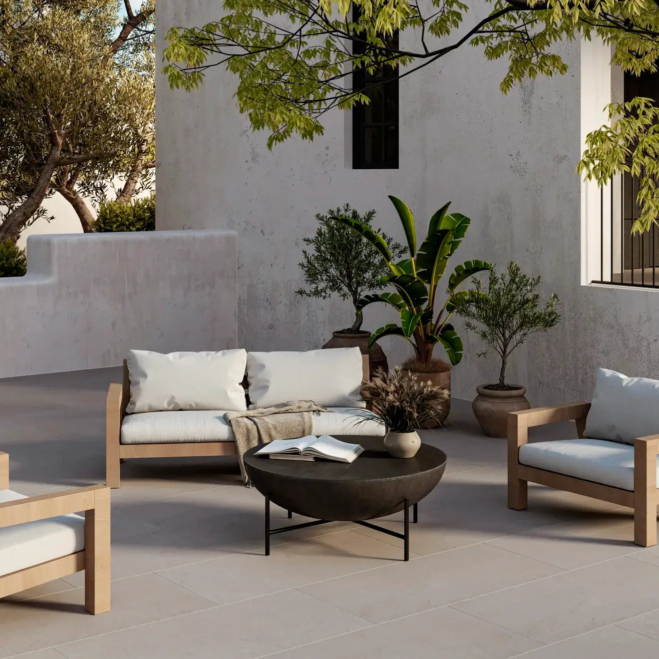 Outdoor lounge area featuring wooden furniture, cushions, and potted plants in a serene setting.