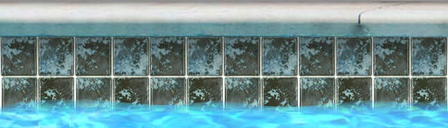 Fujiwa Joya 3x3 Cotto Semi Glossy Porcelain Pool Rated Tiles bordering a sparkling swimming pool.