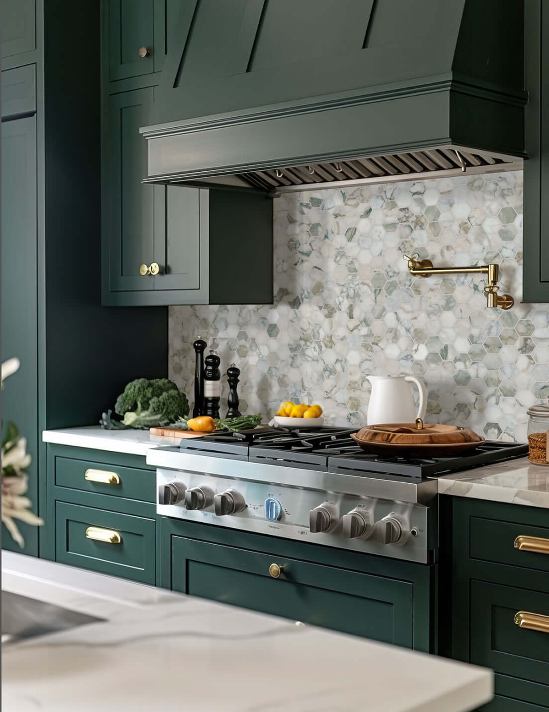 Stylish kitchen featuring 2” Calacatta Green Marble Hexagon Honed Mosaic Tile backsplash with dark green cabinetry.
