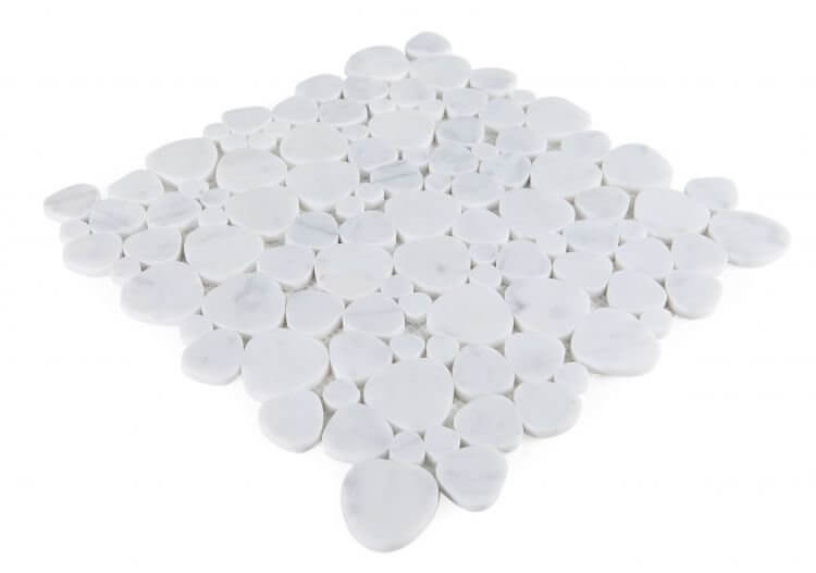 Aphrodite Carrara 12x12 white marble mosaic tiles arranged in heart shapes, showcasing polished natural stone finish.