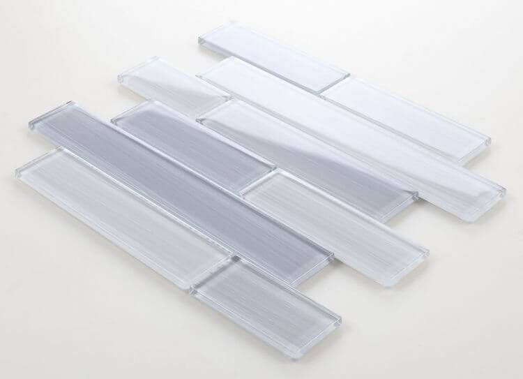 Casale Goose polished light grey glass tiles in subway layout, featuring various chip sizes for swimming pool installation.