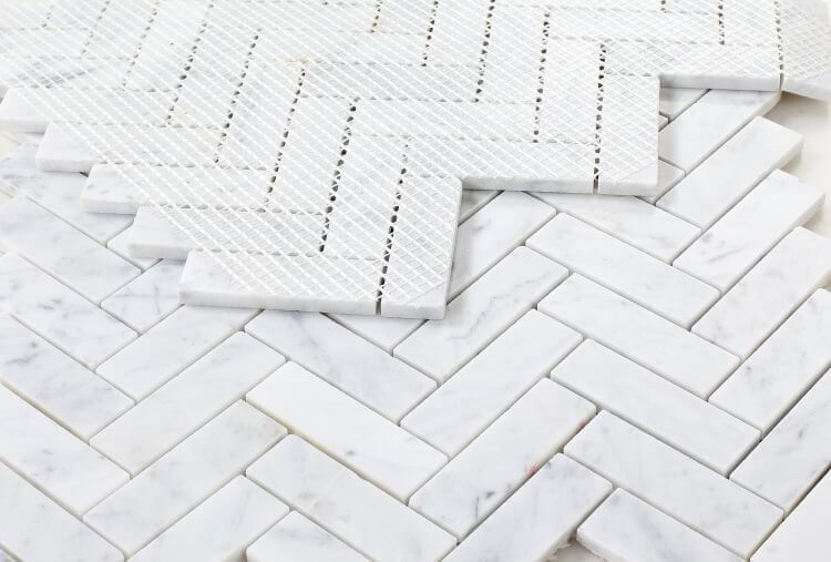 Chevron Long Carrara polished marble mosaic tiles featuring a sophisticated herringbone pattern in elegant white marble.