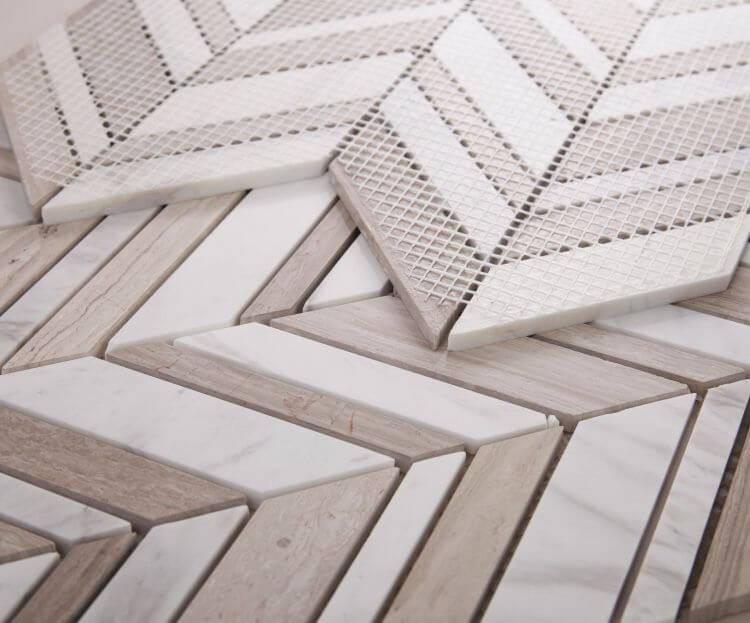 Chevron Shadow Loft mosaic tiles featuring a mix of Volakas White and Haisa Grey marble in polished finish.