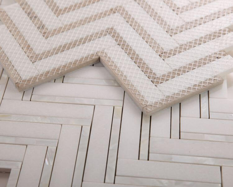 Diana Herringbone Thassos mosaic tiles featuring white Thassos Marble and Mother of Pearl in a chevron pattern.