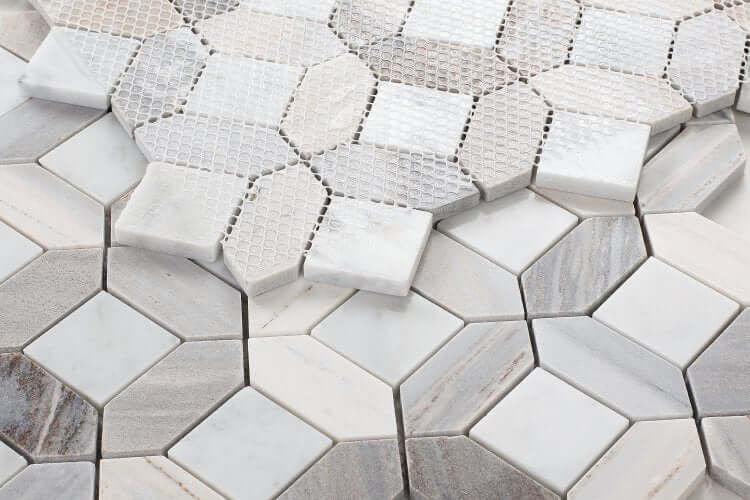 Dimensional Diamond Carrara Blue Sky marble mosaic tiles showcasing soft blue and gray hues in a unique hexagonal pattern.
