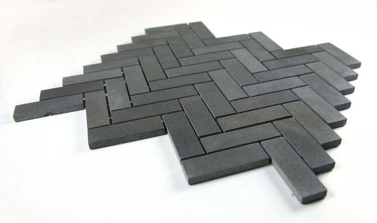 Herringbone Basalt tile in black-grey, 11 x 12.5 inches, showcasing a stylish 1x3 herringbone pattern.