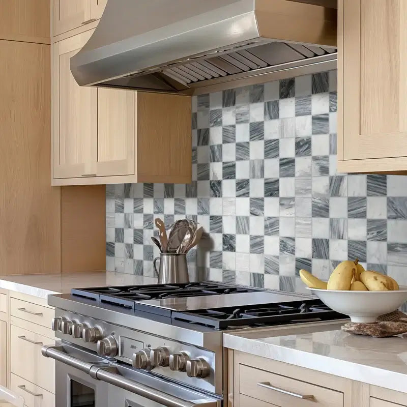 Stylish kitchen featuring a polished Bardiglio Gray and Carrara Blend marble mosaic backsplash with modern appliances.