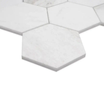 Close-up of 5” Arabescato Venato white hexagon marble mosaic tiles showcasing their sleek, honed surface.