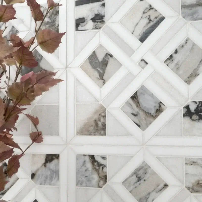 Tessere Pattern Viola 12" X 12" polished marble mosaic tile with elegant veining, complemented by decorative foliage.