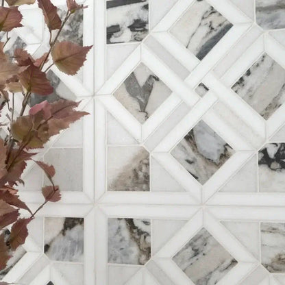Tessere Pattern Viola 12" X 12" polished marble mosaic tile with elegant veining, complemented by decorative foliage.