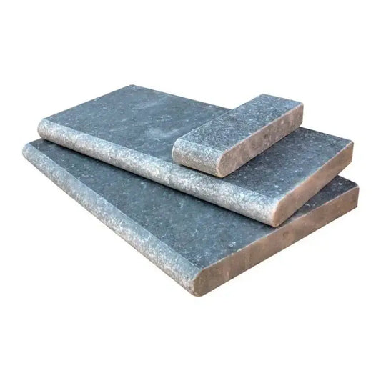 Atlantic Blue tumbled marble pool coping pieces showcasing rustic texture and cool blue tones for poolside decor.